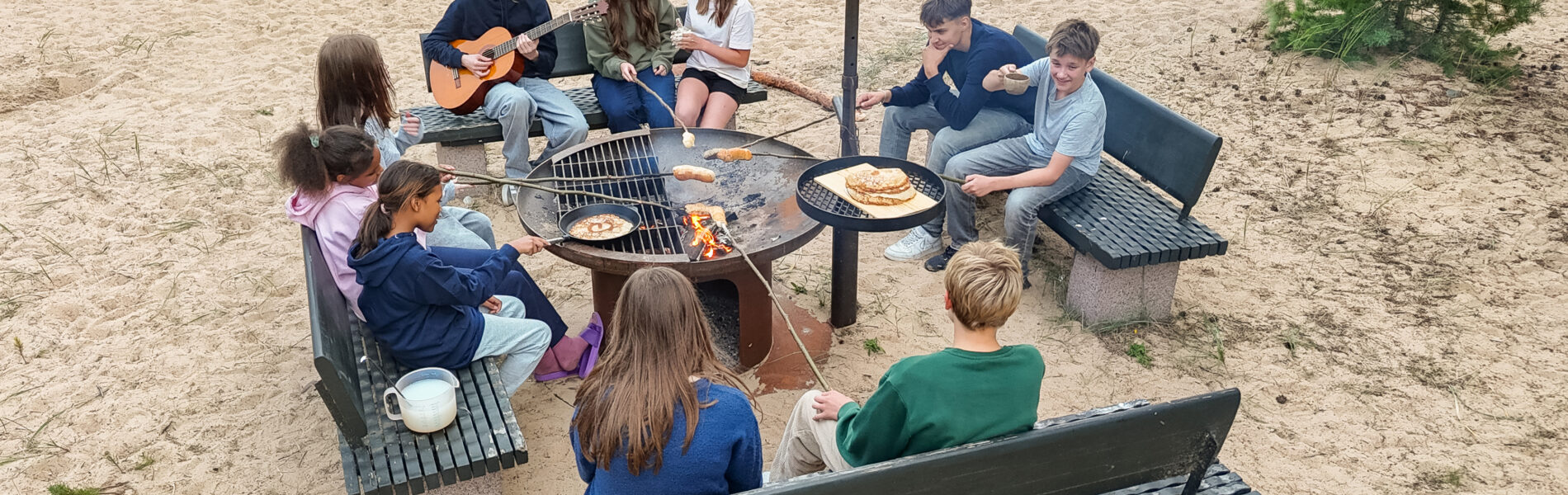 Kids on a bonfire on a beach.