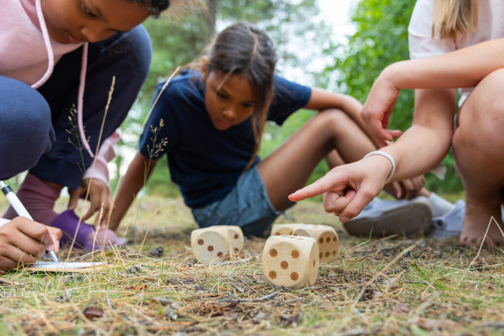 Kids playing outdoor yatzy.